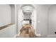Hallway bar area with white cabinets, wine fridge, and arched doorways at 2282 E Zion Way, Chandler, AZ 85249