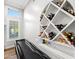 Close-up of the elegant custom white wine rack with a black pool table in the foreground at 2282 E Zion Way, Chandler, AZ 85249