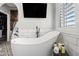 This modern bathroom boasts a stand alone tub and bright natural light at 2282 E Zion Way, Chandler, AZ 85249