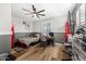 Cozy bedroom with two-tone paint, wood-look floors, and a ceiling fan at 2282 E Zion Way, Chandler, AZ 85249