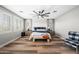 Bright and airy bedroom with plank tile floors, modern fan, and large windows at 2282 E Zion Way, Chandler, AZ 85249
