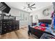 Bright bedroom with sports-themed decor, ceiling fan, and a large window at 2282 E Zion Way, Chandler, AZ 85249