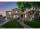 Charming two-story home boasts a landscaped front yard and a welcoming entrance with arched detailing at 2282 E Zion Way, Chandler, AZ 85249