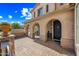 Inviting front porch with arched entryways and brick paving at 2282 E Zion Way, Chandler, AZ 85249