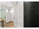 Hallway featuring a black front door, decorative lighting, and access to a bathroom at 2282 E Zion Way, Chandler, AZ 85249