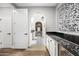 Hallway with tiled floors offers access to a modern bathroom and mini fridge at 2282 E Zion Way, Chandler, AZ 85249