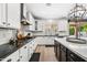 Modern kitchen with white cabinets, dark countertops, stainless appliances, and an island with seating near an outdoor area at 2282 E Zion Way, Chandler, AZ 85249