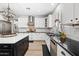 Bright kitchen features stainless appliances, dark countertops, white cabinets and an island with eat-in seating at 2282 E Zion Way, Chandler, AZ 85249
