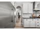 Bright kitchen featuring stainless steel appliances, white cabinetry and adjacent access to the home office at 2282 E Zion Way, Chandler, AZ 85249