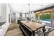 Eat-in kitchen with rustic wood table, stylish chairs, and patio access showcasing the backyard swimming pool at 2282 E Zion Way, Chandler, AZ 85249