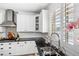 Bright kitchen sink with stainless faucet, white cabinets, and view to backyard at 2282 E Zion Way, Chandler, AZ 85249