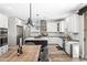 Bright kitchen with white cabinets, black countertops, stainless steel appliances, and a center island with seating at 2282 E Zion Way, Chandler, AZ 85249