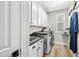 Well-lit laundry room with white cabinetry and modern appliances at 2282 E Zion Way, Chandler, AZ 85249