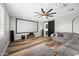 Living room featuring a large screen, gray sectional sofa, and a modern ceiling fan at 2282 E Zion Way, Chandler, AZ 85249