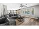 Spacious living room with sectional sofa, decorative fan, and large windows overlooking the backyard and pool at 2282 E Zion Way, Chandler, AZ 85249