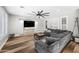 Comfortable living room showcases modern ceiling fan, built-in TV console, and expansive sectional seating at 2282 E Zion Way, Chandler, AZ 85249