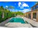 The luxurious backyard oasis features a sparkling pool, sun loungers, lush landscaping and covered patio at 2282 E Zion Way, Chandler, AZ 85249