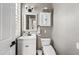 Charming powder room featuring a decorative mirror, white vanity, and modern fixtures at 2282 E Zion Way, Chandler, AZ 85249
