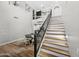 Elegant staircase with metal railing, wood steps, and adjacent dining area at 2282 E Zion Way, Chandler, AZ 85249