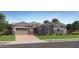 Charming single-story home with a stone-accented facade, manicured lawn, and a two-car garage, perfect for modern living at 23037 E Nightingale Rd, Queen Creek, AZ 85142