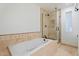 Elegant bathroom with a soaking tub, glass shower, and tiled accents at 2313 S Grandview Ave, Tempe, AZ 85282