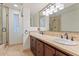 Bright bathroom with double sinks, a glass enclosed shower, and a large mirror at 2313 S Grandview Ave, Tempe, AZ 85282