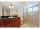 Bathroom with granite countertop, wood cabinets and walk in shower at 2313 S Grandview Ave, Tempe, AZ 85282