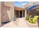 Inviting gated front courtyard with seating area, umbrella and desert landscaping at 2313 S Grandview Ave, Tempe, AZ 85282
