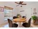 Cozy dining area with seating for four, a ceiling fan, and a large window at 2313 S Grandview Ave, Tempe, AZ 85282