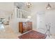 Bright foyer featuring neutral tile floors, wooden console table, staircase, and chandelier at 2313 S Grandview Ave, Tempe, AZ 85282