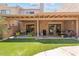 Inviting covered patio with ample seating, green grass and sliding glass doors for seamless indoor-outdoor living at 2313 S Grandview Ave, Tempe, AZ 85282