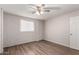 Light filled bedroom with painted brick wall, new flooring and contemporary ceiling fan at 2333 W Glenrosa W Ave # 113, Phoenix, AZ 85015