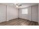 This bedroom is decorated with white painted brick and has wood-look floors at 2333 W Glenrosa W Ave # 113, Phoenix, AZ 85015