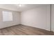 The bedroom features a brick wall, a window for natural light, and new vinyl flooring at 2333 W Glenrosa W Ave # 113, Phoenix, AZ 85015