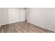 This is a bedroom with wood-look flooring and a closet with white doors at 2333 W Glenrosa W Ave # 113, Phoenix, AZ 85015