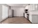 Modern kitchen featuring stainless steel appliances, white cabinets, and a stylish brick wall at 2333 W Glenrosa W Ave # 113, Phoenix, AZ 85015