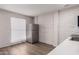 View of kitchen with stainless steel refrigerator, white countertops, and white brick wall at 2333 W Glenrosa W Ave # 113, Phoenix, AZ 85015