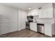 Updated kitchen with stainless steel appliances, white cabinets, and brick accent wall at 2333 W Glenrosa W Ave # 113, Phoenix, AZ 85015