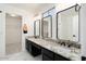 Bathroom with a double sink vanity with granite countertops, modern fixtures and marble flooring at 23772 W Grove St, Buckeye, AZ 85326