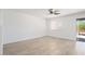 Spacious bedroom with hardwood floors, a ceiling fan, and a sliding glass door at 23772 W Grove St, Buckeye, AZ 85326