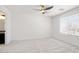 Bright bedroom featuring neutral carpet, ceiling fan, and window with horizontal blinds at 23772 W Grove St, Buckeye, AZ 85326