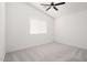 Bright bedroom with neutral carpet, ceiling fan and a window with horizontal blinds at 23772 W Grove St, Buckeye, AZ 85326