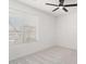 Bright bedroom featuring neutral carpet, ceiling fan, and window with horizontal blinds at 23772 W Grove St, Buckeye, AZ 85326