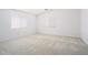Spacious bedroom features neutral carpet and two windows with horizontal blinds at 23772 W Grove St, Buckeye, AZ 85326