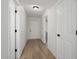 Bright hallway with new hardwood floors, neutral colored walls, and modern lighting at 23772 W Grove St, Buckeye, AZ 85326