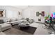Staged living room with modern furniture, stylish decor, and bright natural light at 23772 W Grove St, Buckeye, AZ 85326