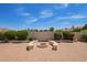 A backyard featuring a fire pit, landscaping, and a large brick patio at 2457 E Melrose St, Mesa, AZ 85213