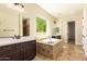 Luxurious bathroom with a large soaking tub, double vanities, and natural light from a large window at 2457 E Melrose St, Mesa, AZ 85213
