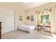Bright bedroom with natural light, a full bed and a desk space at 2457 E Melrose St, Mesa, AZ 85213