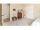 Bright bedroom with neutral carpet, antique furniture and ensuite bathroom at 2457 E Melrose St, Mesa, AZ 85213